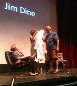 Jim Dine receiving bathrobe from Tamarind Press director Marjorie Devon in Alberquerque